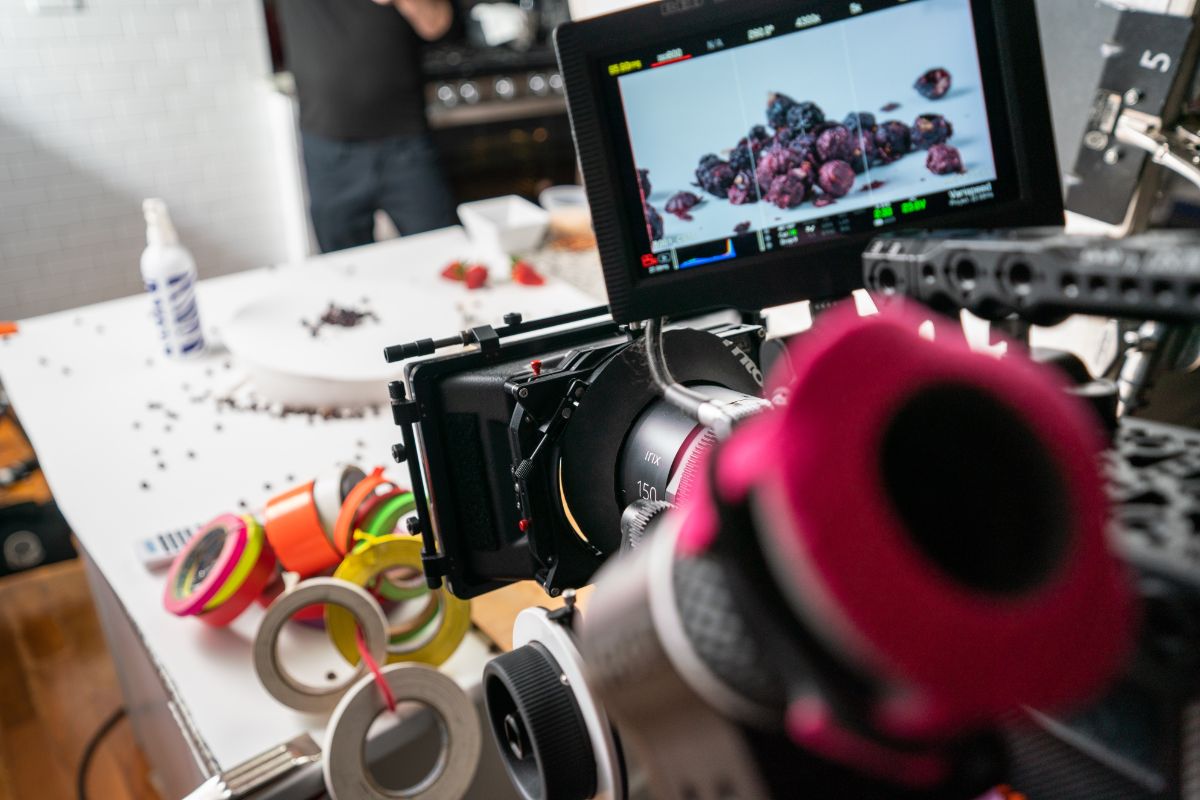Camera filming tabletop footage of food for brand marketing